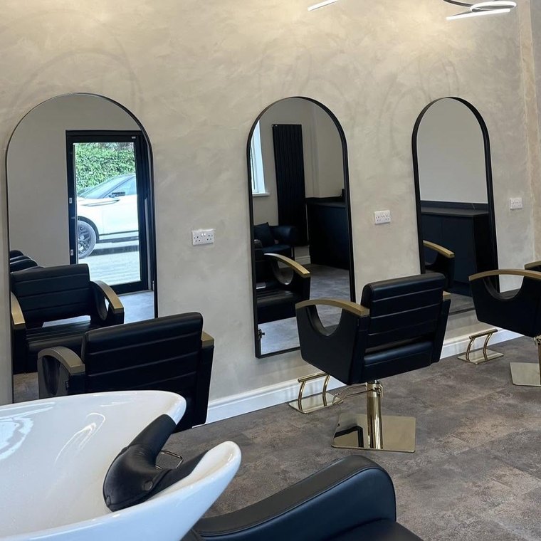 Arched mirrors, gold styling chairs and the backwash area
