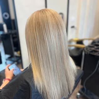 Long blonde balayage with a soft root melt
